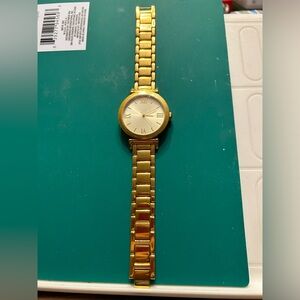 STEEL BY DESIGN gold tone men’s watch fold over clasp fits up to an 8.5 in wrist